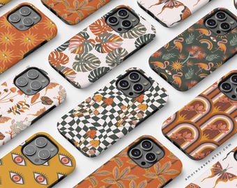 May include: A collection of phone cases with various retro-inspired designs. The designs include mushrooms, checkerboards, rainbows, eyes, and tropical leaves. The cases are all in shades of orange, brown, white, and green.