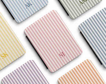 May include: A collection of rectangular tablet cases featuring vertical stripes in various pastel colours including blue, green, yellow, pink, purple, and orange. Each case displays a two-letter monogram in the centre and the text AMORE CASES.