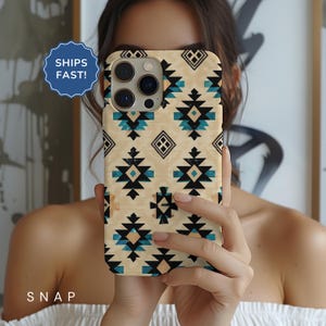 May include: A beige iPhone case with a geometric pattern in black, blue, and white. The case has a cutout for the camera lens.