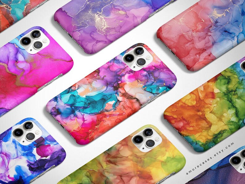 May include: A set of colorful phone cases with abstract designs. The cases feature a variety of colors, including pink, blue, green, yellow, and orange. The designs are reminiscent of alcohol ink art.