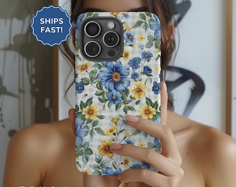 May include: A white and blue floral phone case with a gingham pattern. The case has a cutout for the camera lens and a blue floral design.
