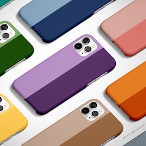 May include: A collection of colorful phone cases with a two-tone design. Each case features a different color combination, such as green and purple, blue and orange, and pink and yellow. The cases are all designed for the iPhone 13 Pro Max.