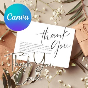 May include: A white thank you card with a handwritten message that reads "Thank You" in a cursive font. The card is surrounded by white flowers and green leaves.