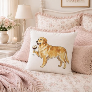 May include: A square white throw pillow featuring a detailed illustration of a golden retriever dog standing in profile. The dog is depicted holding a stemmed glass filled with a dark beverage topped with foam in its front paw.