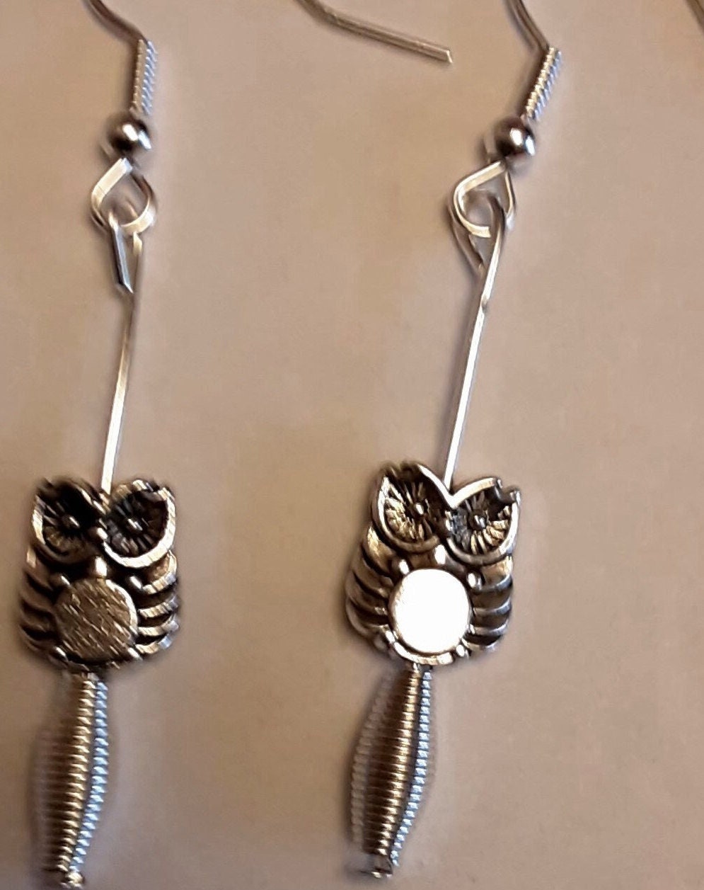 A Tibetan Silver Owl Sitting on an Imitation Spring Earrings with Silver Wires.