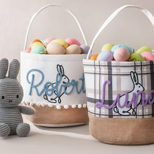 two Easter baskets, each with a stuffed bunny toy and decorated with the names "Robert" and "Luna" embroidered on them.