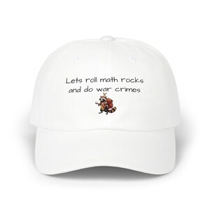 May include: White baseball cap with the text "Lets roll math rocks and do war crimes" and a cartoon raccoon graphic. The cap has a curved brim and a rounded crown. The text and graphic are in black.