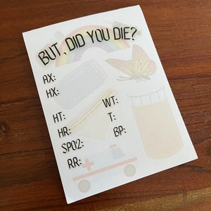 May include: A white card with the text "BUT, DID YOU DIE?" in black. The card has a rainbow, a butterfly, a can, and a cartoon ambulance with a red cross on it. The card also has a list of medical terms with blank spaces for filling in vital signs, including AX, HX, HT, WT, HR, T, SP02, BP, and RR.
