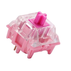 以下が含まれることがあります： 透明なプラスチック製のハウジングと紫色の十字形のキーキャップが付いたピンクのメカニカルキーボードスイッチです。