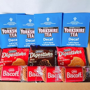 May include: A gift basket filled with a variety of treats, including four boxes of Yorkshire Tea decaf tea bags, two boxes of McVitie's Digestives biscuits, and two boxes of Lotus Biscoff biscuits.