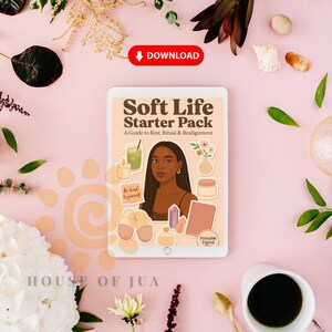 May include: A digital tablet displaying the "Soft Life Starter Pack" cover, featuring a woman's illustration, candles, and other self-care items. The tablet is surrounded by flowers, a cup of coffee, and decorative elements on a pink background.