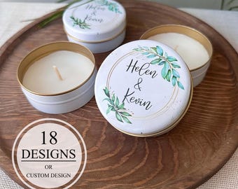 May include: Four white candles in small tins with gold rims, arranged on a wooden tray. The lids of two candles are visible, each with the text "Helen & Kevin" surrounded by a green floral design. The image also includes a graphic with the text "18 Designs or Custom Design."