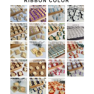 K&ouml;nnte beinhalten: Eine Tabelle mit verschiedenen Bandfarben f&uuml;r Schokoladen-Geschenke. Die Farben umfassen Wei&szlig;, Lila, Blau, Marineblau, Schwarz, Rosa, Smaragdgr&uuml;n, Grau, Beige, Gelb, Nilblau, Rot, Burgunderrot, Braun, Fuchsia, Lila, Hellgr&uuml;n, K&ouml;nigsblau und Orange.