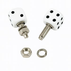 May include: Two white dice with black dots, mounted on threaded studs, with a nut and washer. The dice are a classic six-sided shape, and the dots are evenly spaced.