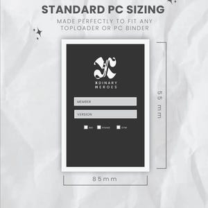 May include: A black and white card with the text "XDINARY HEROES" and fields for "MEMBER" and "VERSION". The card is 85 mm wide and 55 mm tall, designed to fit toploaders or PC binders. Text at the top reads "STANDARD PC SIZING".