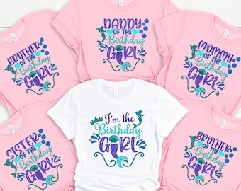 May include: Six pink and white t-shirts with mermaid-themed birthday designs. The shirts say "Brother of the Birthday Girl", "Sister of the Birthday Girl", "Daddy of the Birthday Girl", "Mommy of the Birthday Girl", "I'm the Birthday Girl", and "Brother of the Birthday Girl".