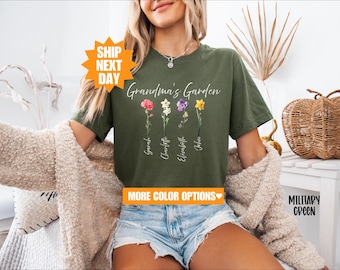 May include: A green t-shirt with the text "Grandma's Garden" and a floral design. The flowers are labeled with the names "Sarah", "Charlotte", "Elizabeth", and "John".