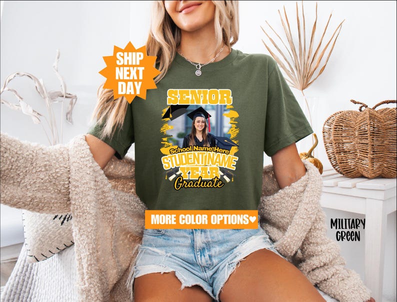 May include: A green t-shirt with a yellow graphic that says "Senior" and has a photo of a graduate in a cap and gown. The graphic also includes the text "School Name Here", "STUDENT NAME", "YEAR", and "Graduate".