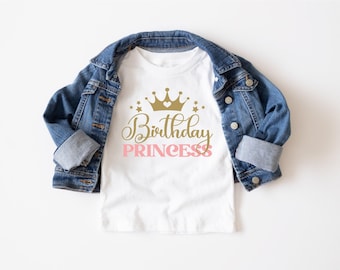 May include: White t-shirt with a gold crown and the text "Birthday Princess" in pink lettering.