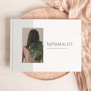 May include: A white presentation book with the text "MINIMALIST SIMPLE COMPANY PRESENTATION" on the cover. The cover also features a photo of a person with a large green leaf behind them.