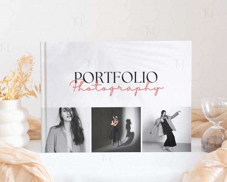 May include: A white portfolio book with the text "PORTFOLIO Photography" in black and red. The book features three black and white photographs of people.