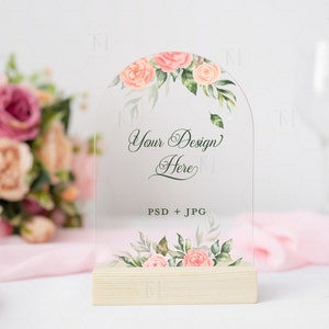 May include: A clear acrylic sign with a floral design and the text "Your Design Here" and "PSD + JPG". The sign is on a wooden base.