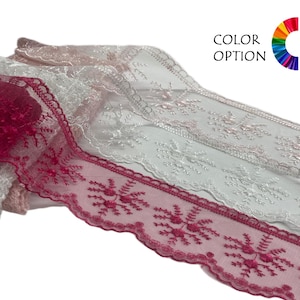 May include: Close-up of several lace trims in shades of white and burgundy. The burgundy trim features a floral pattern along the scalloped edge. The text "COLOR OPTION" is visible in the upper right corner, with a color wheel.