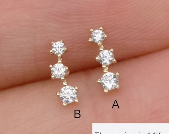 May include: A pair of gold earrings with three small clear cubic zirconia stones each. The earrings are 20 gauge (0.82 mm) and come in four different lengths: 5 mm, 6 mm, 8 mm, and 10 mm. Choose 1 from 4.