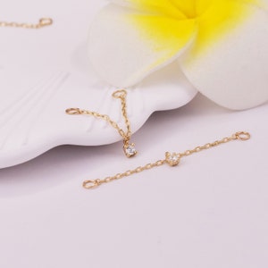 May include: Two gold chains with small diamond accents. The chains are designed to be used as extenders for necklaces or bracelets.