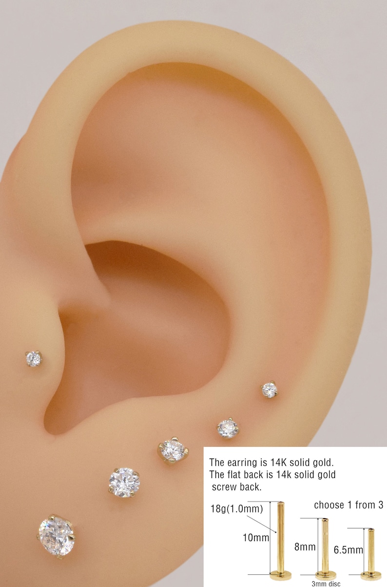 May include: A close-up of a gold earring with a small diamond. The earring is available in three sizes: 10mm, 8mm, and 6.5mm. The earring is made of 14k solid gold and has a flat back.