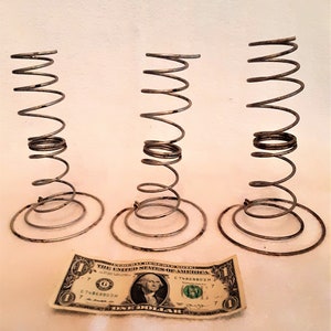 May include: Three vintage metal bed spring coils with a one dollar bill for scale.