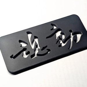 May include: A white ceramic mug with a black handle and the text "But First, Coffee" in a black, handwritten-style font. The mug is on a white surface.