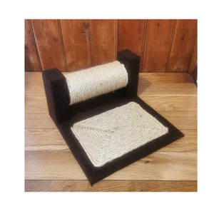 May include: A brown cat scratching post with a sisal rope scratching surface and a rectangular base. The post has a horizontal, cylindrical scratching area and a square base with a sisal rope pad.