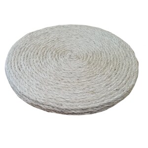 May include: A round, white, woven cushion made of natural fibers. The cushion is thick and has a circular pattern.