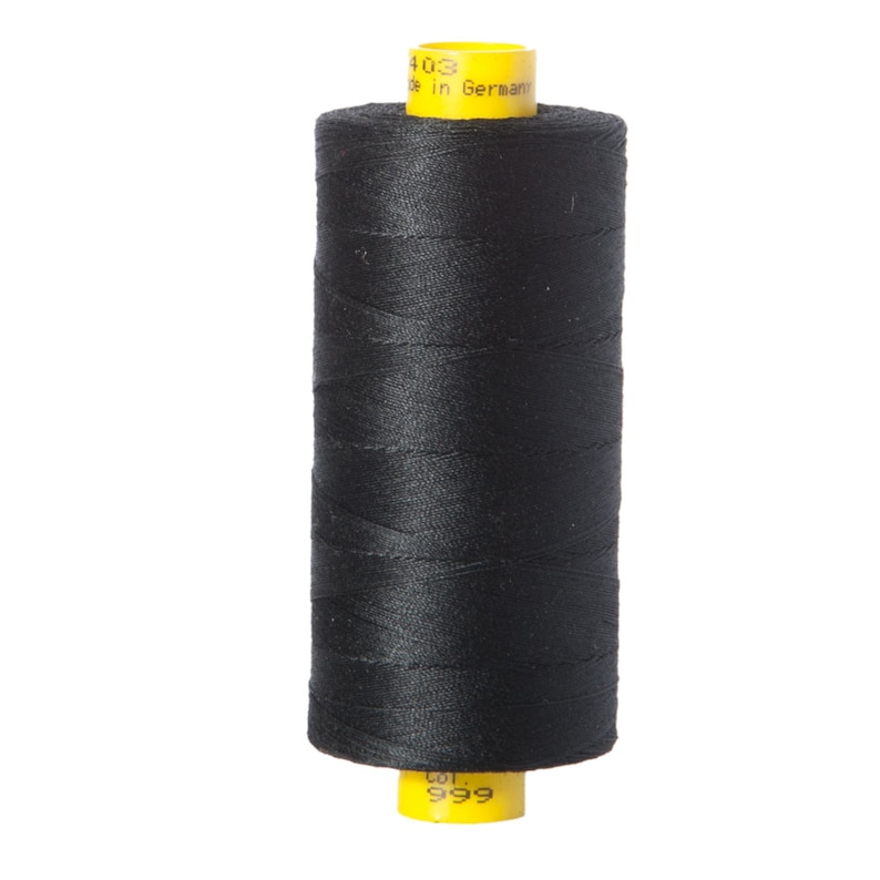 May include: A spool of black thread with a yellow label that reads "403 Made in Germany Col. 999".