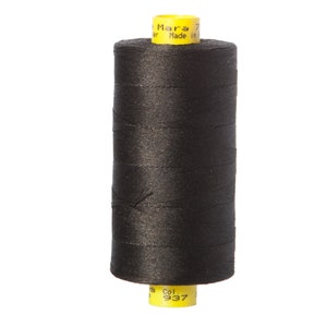 May include: A spool of black thread with yellow labels that read "Mara 70" and "Made in Italy" and "Col. 937".