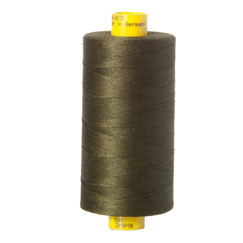 May include: A spool of dark green thread with a yellow label that reads "Col. 399" and "Made in Germany".