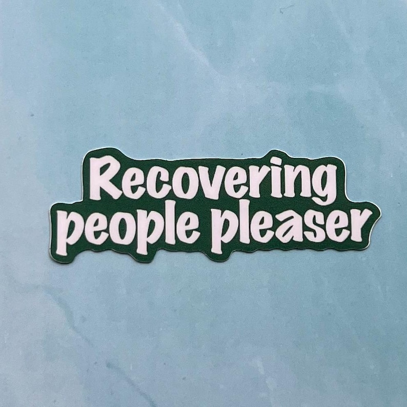 May include: Green sticker with white text that reads "Recovering people pleaser".