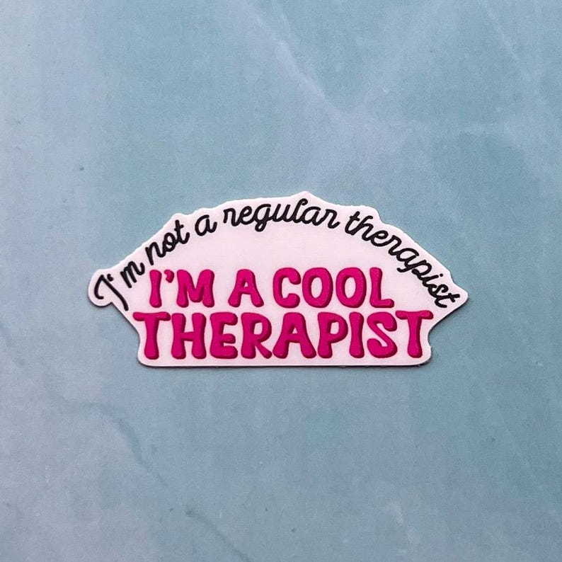 May include: White sticker with a pink curved text that reads "I'm not a regular therapist I'm a cool therapist".