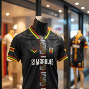 May include: Black jersey with the word "ZIMBABWE" in white. The jersey has a V-neck with red, yellow, and green trim. The sleeves also have the same trim. A small emblem is on the chest. The jersey is on a mannequin.