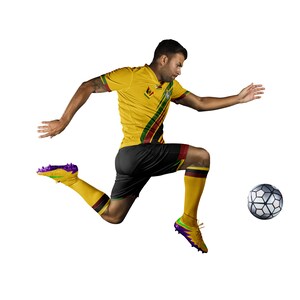 May include: A soccer player in a yellow jersey with black shorts and yellow socks kicks a soccer ball. The jersey has green and red stripes. The soccer cleats are yellow and purple. The soccer ball is black and white.