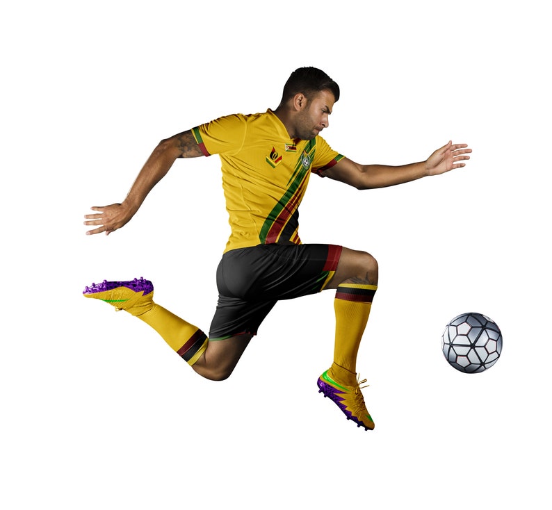 May include: A soccer player in a yellow jersey with black shorts and yellow socks kicks a soccer ball. The jersey has green and red stripes. The soccer cleats are yellow and purple. The soccer ball is black and white.
