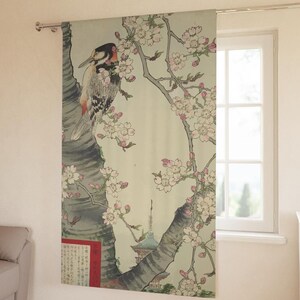 May include: A decorative curtain featuring a Japanese woodblock print. The artwork depicts a woodpecker perched on a tree branch with cherry blossoms. The print includes a pagoda and Japanese text, with a color palette of gray, pink, and green.
