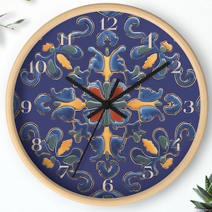 May include: Round wall clock with a wooden frame and a navy blue face. The clock face features a symmetrical floral design in shades of blue, yellow, and orange. Black clock hands and white numerals complete the design. A decorative accent for any room.