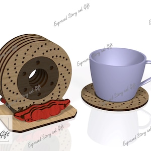 Pode incluir: Um conjunto de bases de madeira com um design de disco de freio, uma pinça de freio vermelha e uma chávena de chá roxa clara com uma base a condizer. O conjunto é feito de madeira e tem um tema automóvel. O texto "Story & Gift" é visível.