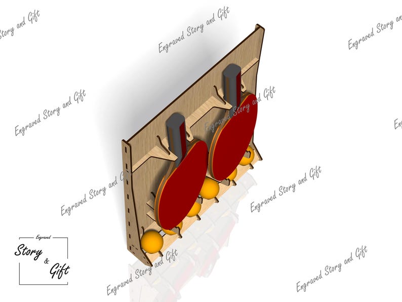 May include: Wooden ping pong paddle and ball holder. The holder is made of light brown wood and features two red paddles and several yellow balls. The text "Engraved Story and Gift" is visible.