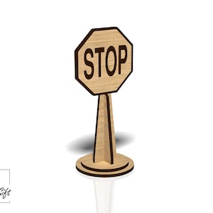 Op de afbeelding: Een houten stopbord met het woord "STOP" in zwarte letters. Het bord is gemonteerd op een houten standaard.
