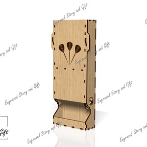 May include: A wooden dart holder with a slot for darts and a cutout design of three darts. The holder is made of light brown wood and has a natural wood finish.