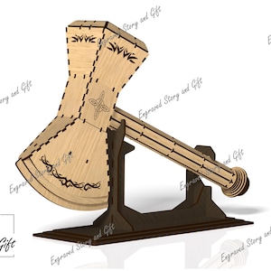 May include: A wooden axe with intricate carvings and a Celtic knot design, displayed on a dark brown stand. The axe is made of light wood and has a natural finish.