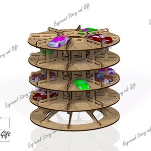 May include: A wooden toy car display stand with multiple levels, holding various colorful toy cars. The stand is made of light brown wood and has a circular design. The text "Story & Gift" is visible.